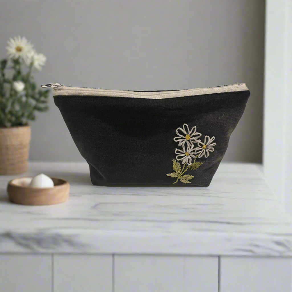 Black pouch with floral embroidery on a white background