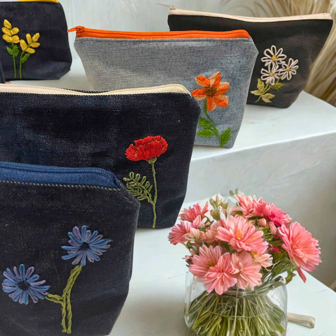 Upcycled denim makeup bag with handmade embroidered flower