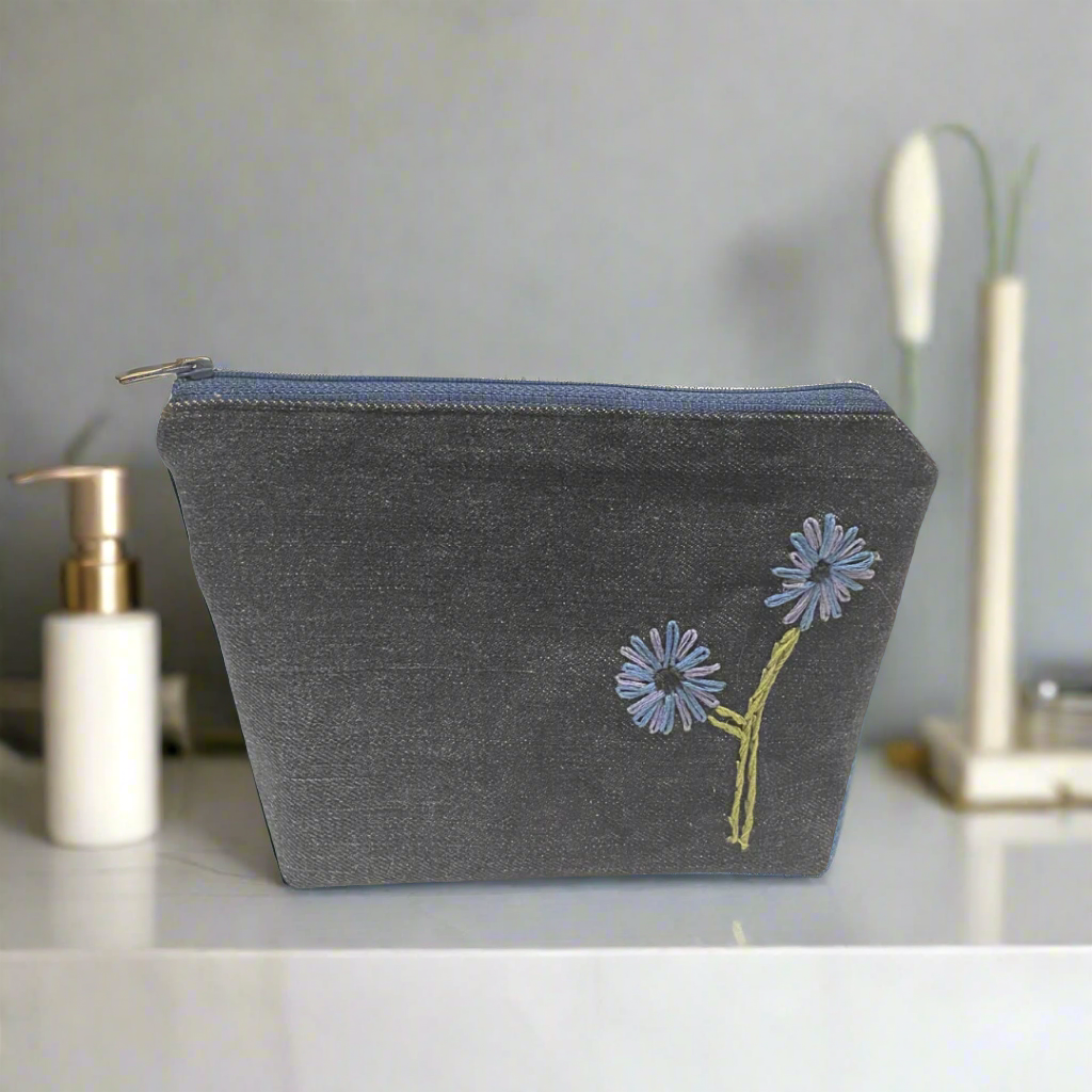 Upcycled denim makeup bag with handmade embroidered flower