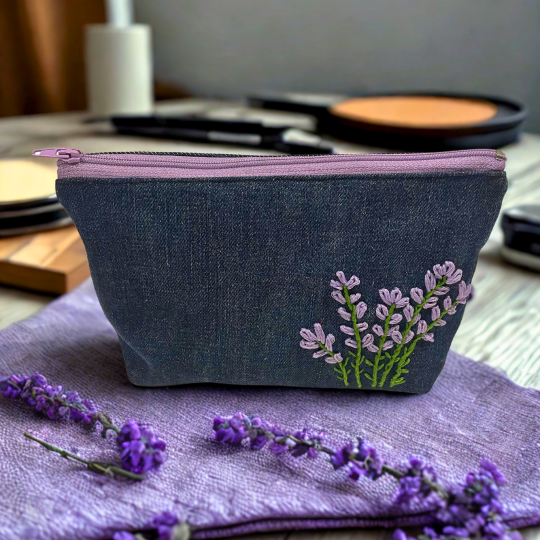 Upcycled denim makeup bag with handmade embroidered flower