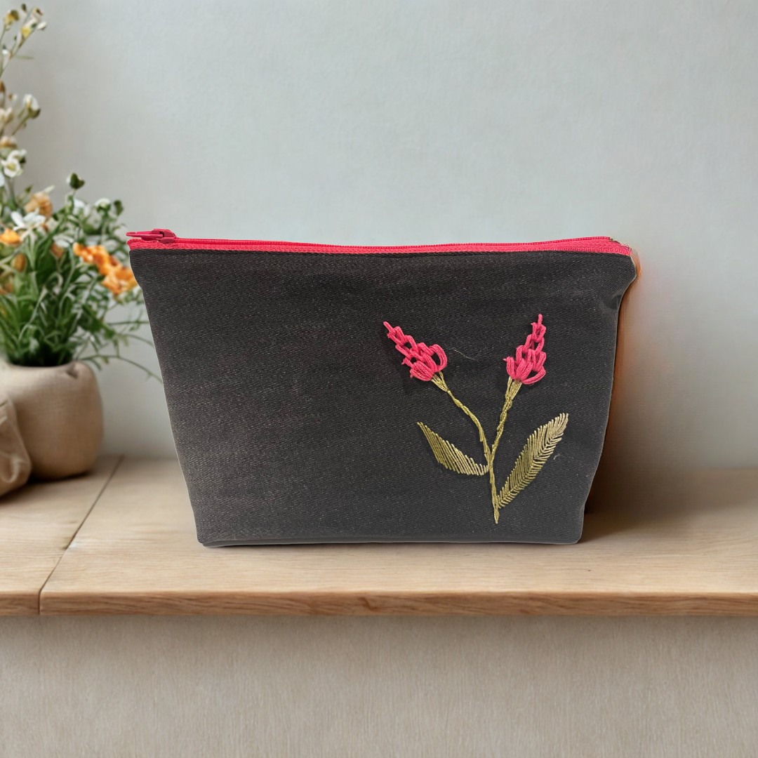 Upcycled denim makeup bag with handmade embroidered flower