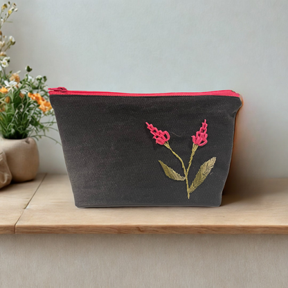 Upcycled denim makeup bag with handmade embroidered flower