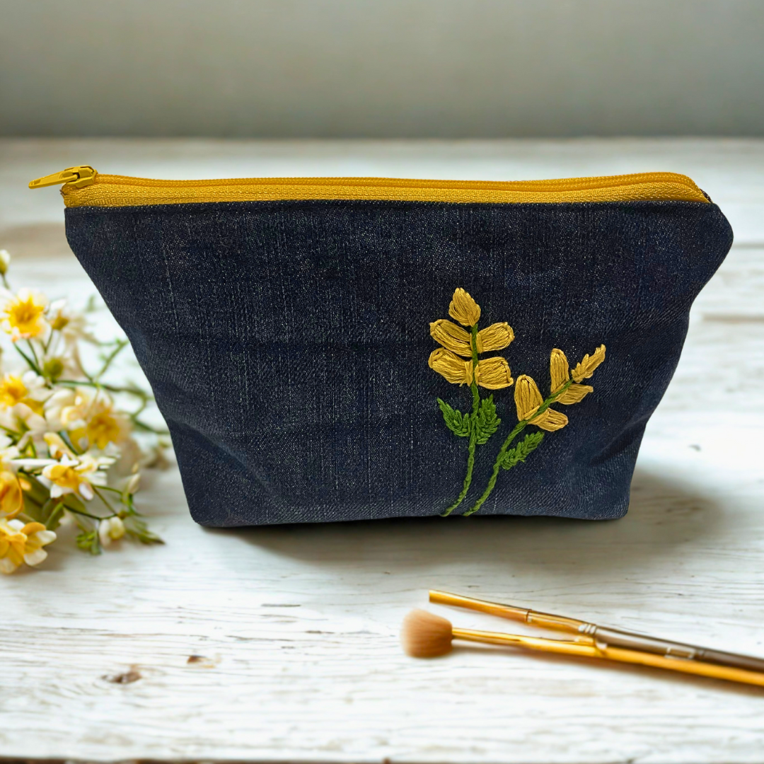 Upcycled denim makeup bag with handmade embroidered flower
